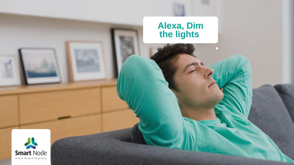 Man resting on sofa commanding alexa to dim the light using smart home automation system